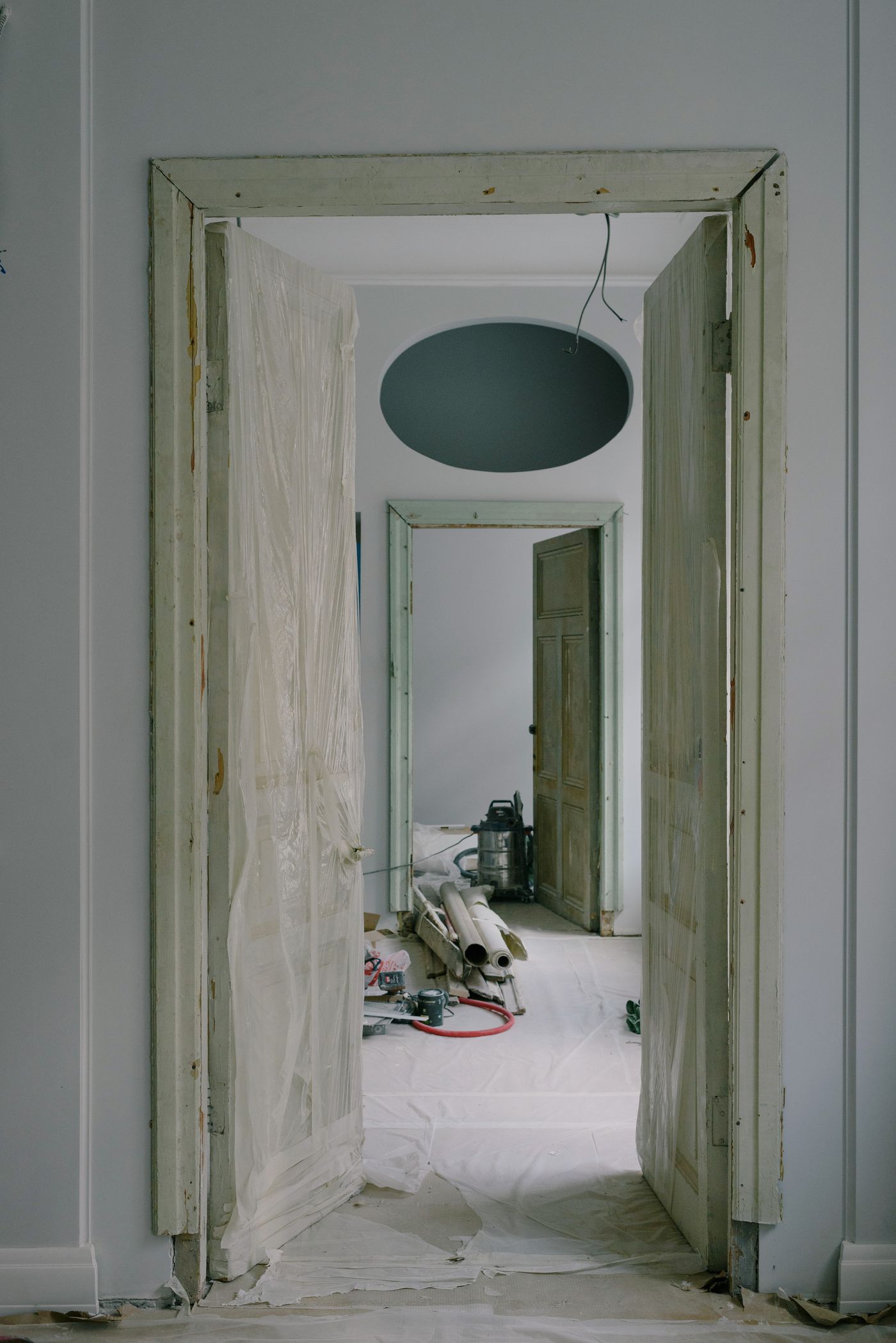 Plastic sheeting set up over a doorway to contain a work area during remediation